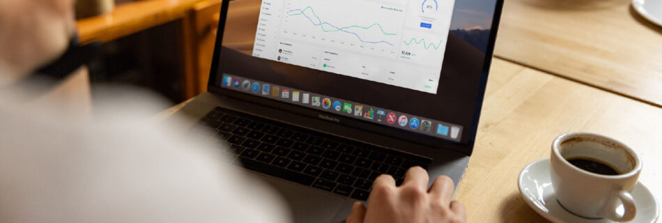 Business intelligence dashboard on a laptop screen showing charts and KPI tracking